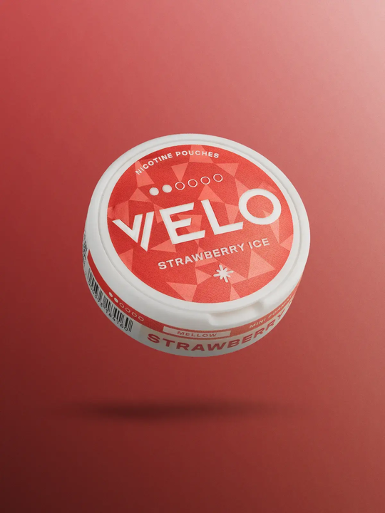 A pack of Strawberry Ice Velo Nicotine pouches floating on a red background.