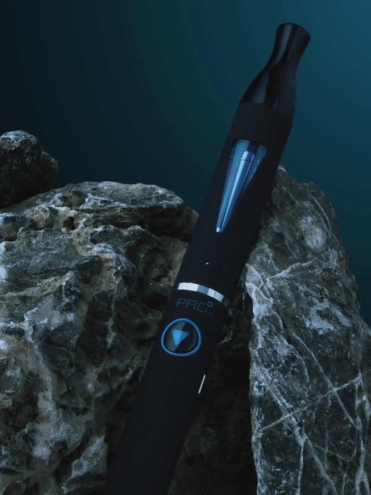 A blu Pro kit with battery and clearomizer assembled, leaning against some rocks in front of a stylised dark background.