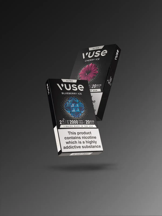 A pack of Blueberry Ice & a pack of Cherry Ice Vuse Ultra pods floating on a black-grey background