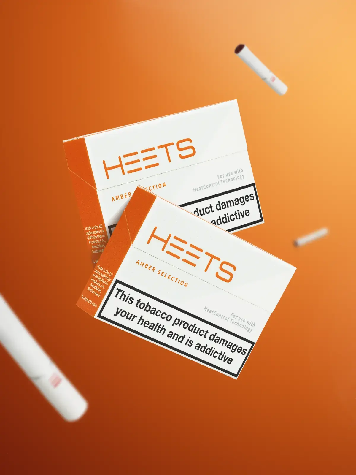 Two packs of IQOS HEETS in Amber flavour, floating in front of an orange background