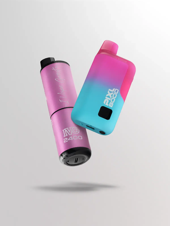 A pink IVG 2400 pod kit and a blue-pink PIXL 8000 pod kit floating side by side on a white-grey background