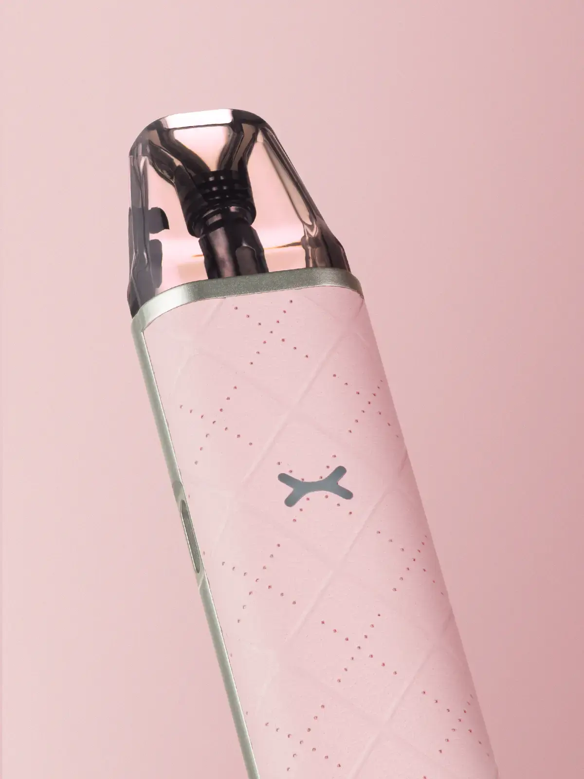 OXVA Xlim Go in Pink, showing the top-half and its refill pod in front of a pink background