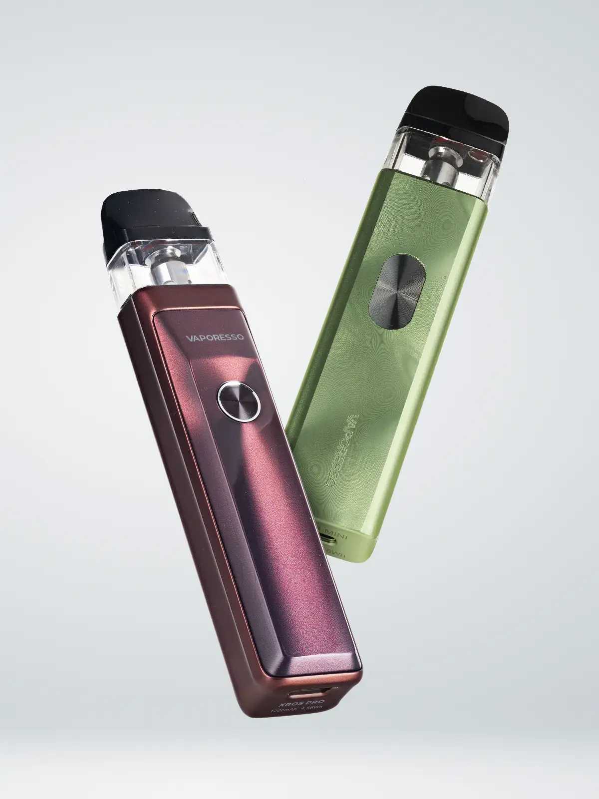 A Vaporesso XROS 4 Mini device in Green, and a Vaporesso XROS Pro device in Red, floating in front of a light background.